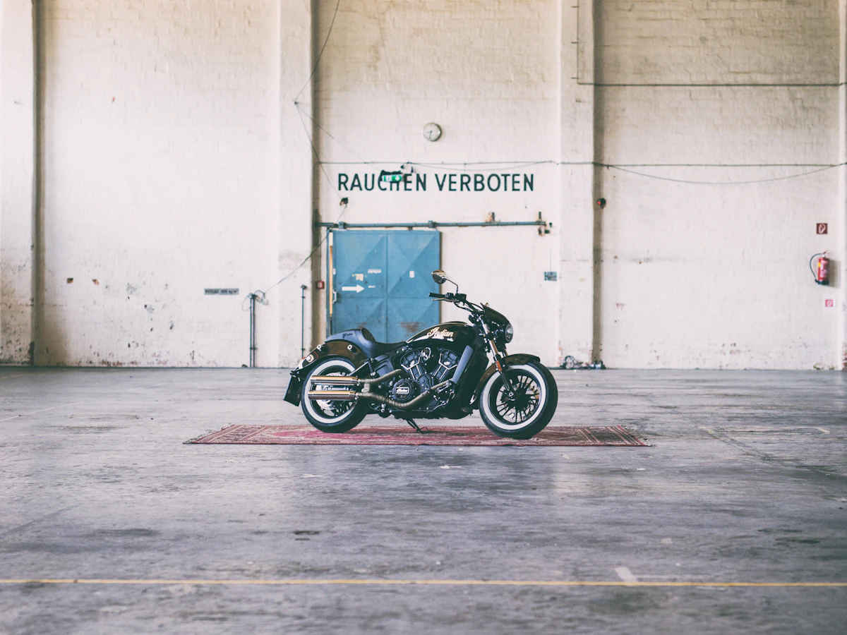 Motorcycle parked inside a spacious industrial shop interior