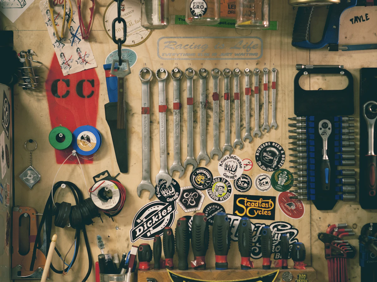 Organized workshop hand tools hanging on a service wall