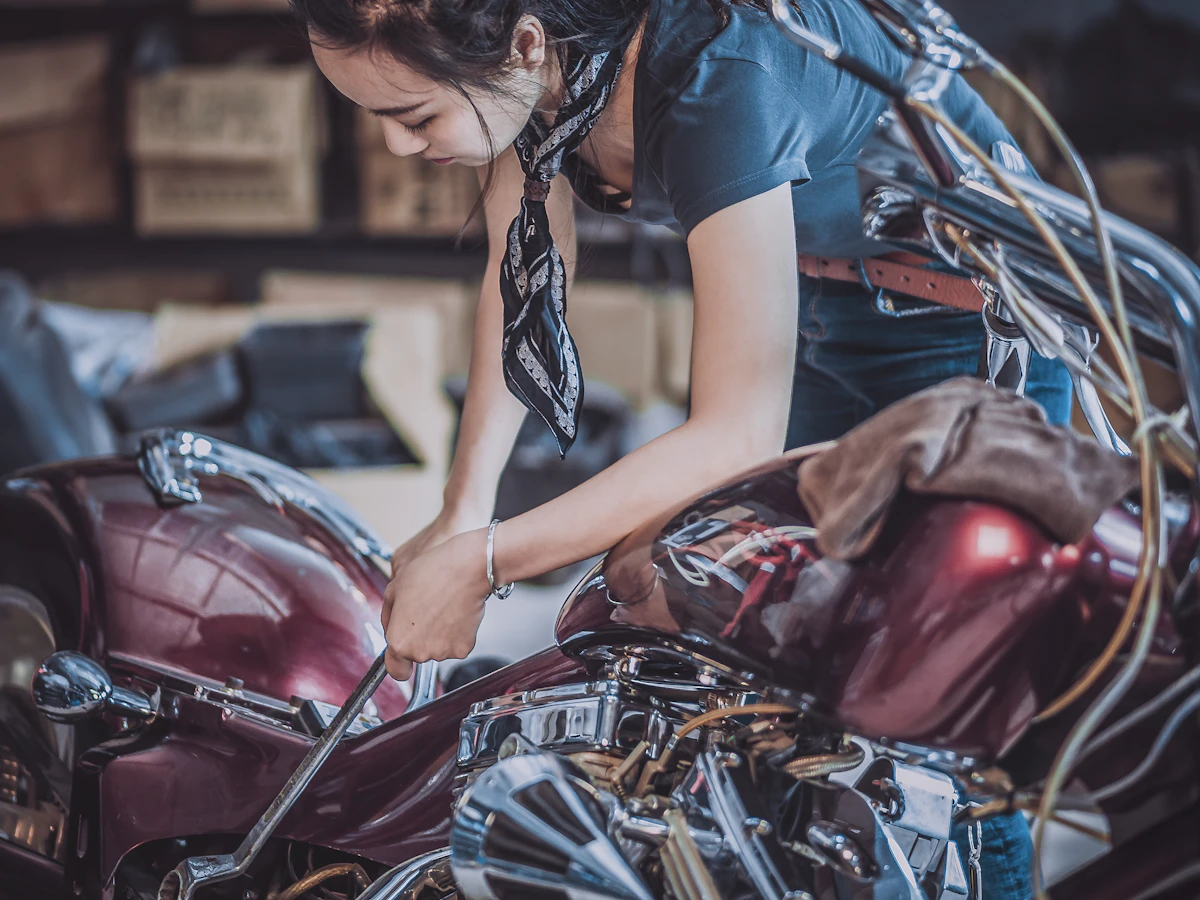 Motorcycle mechanic using a wrench on a custom motorcycle