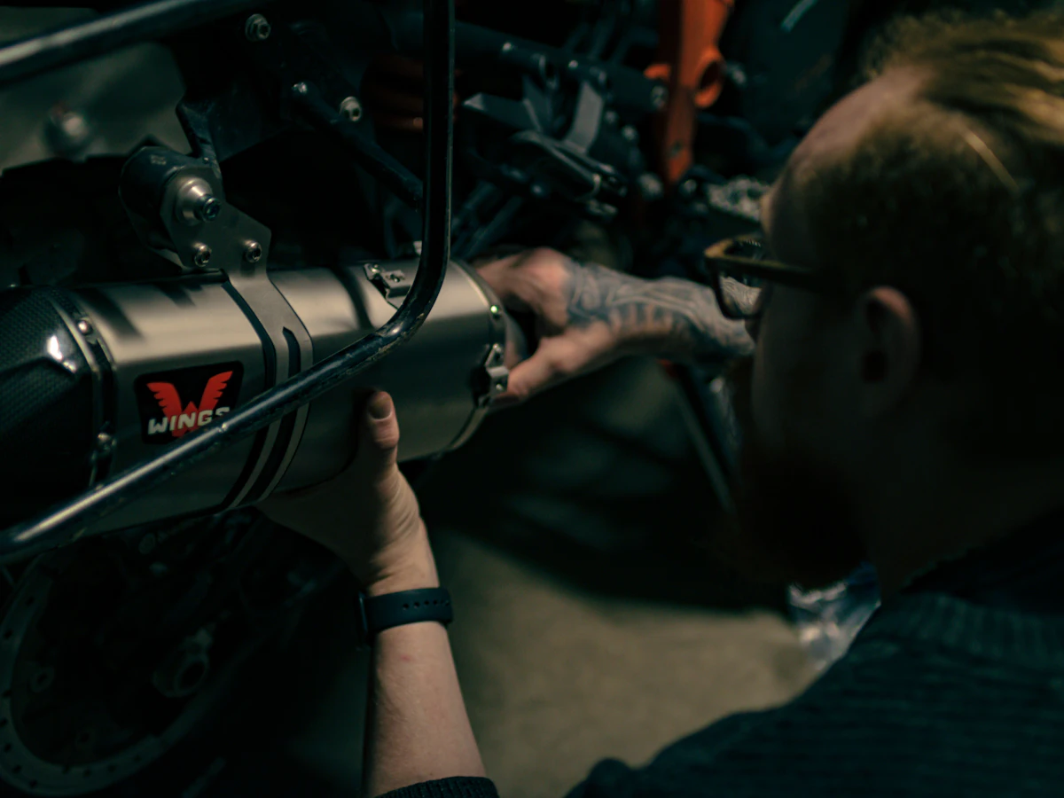 Mechanic completing detailed service work on a motorcycle