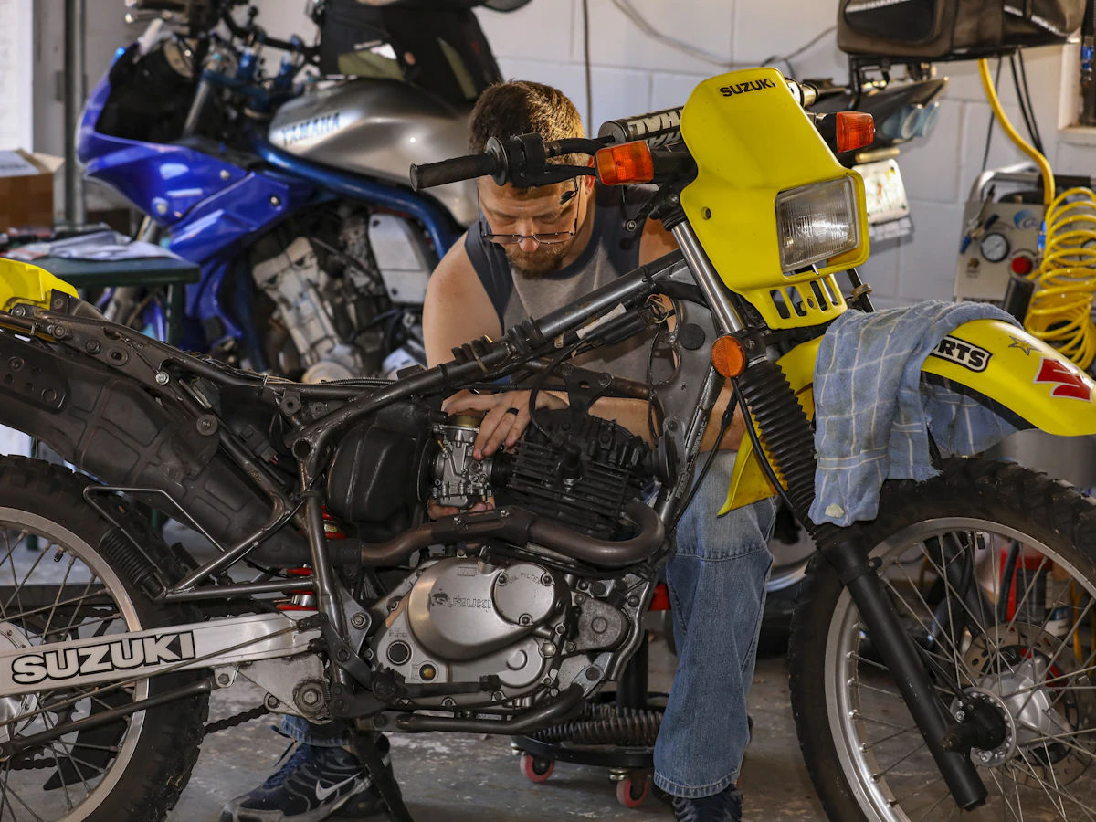 Mechanic inspecting motorcycle frame and suspension components